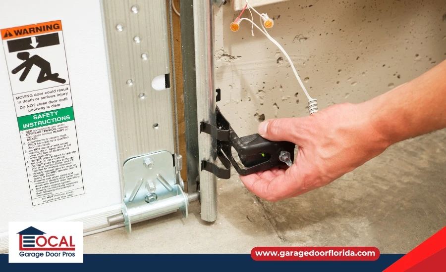 Garage door sensor with debris blocking lens