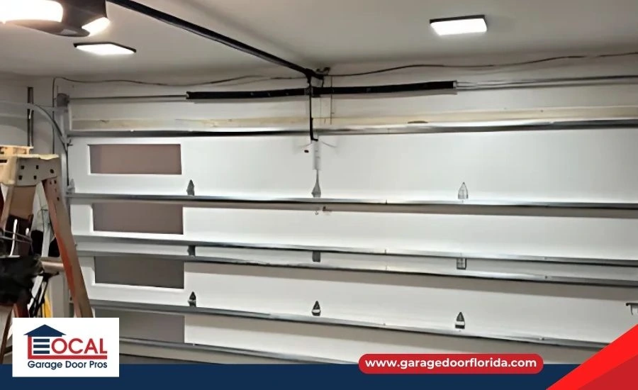 New garage door installation with visible metal tracks and brackets