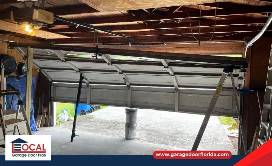 Partially open garage door showing uneven lifting