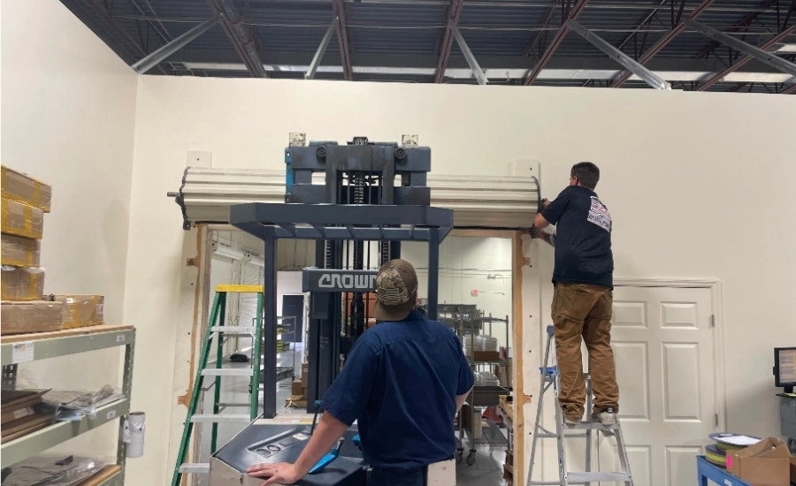 Durable commercial steel roll-up door repair in progress.