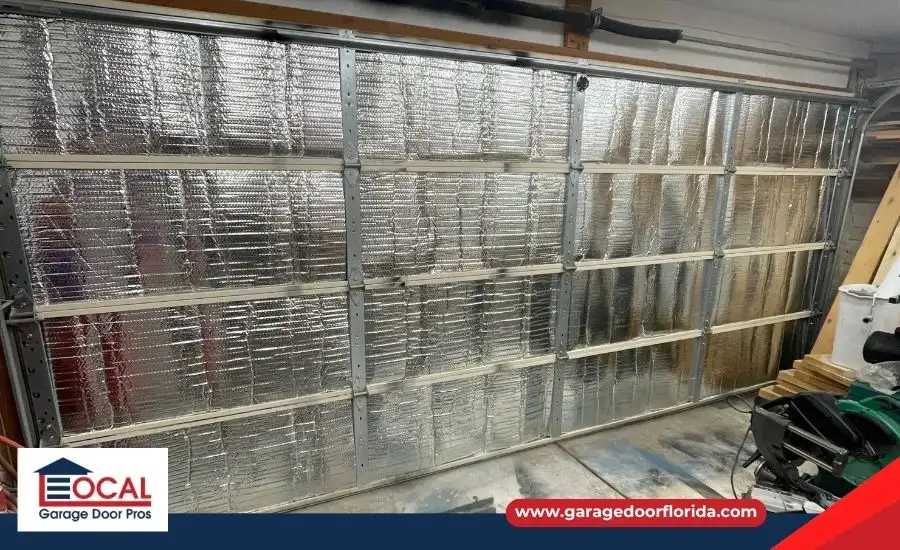 A cutaway graphic showing the 3-layer sandwich construction of an insulated garage door, with a steel front, polyurethane foam core, and steel back for maximum R-Value.