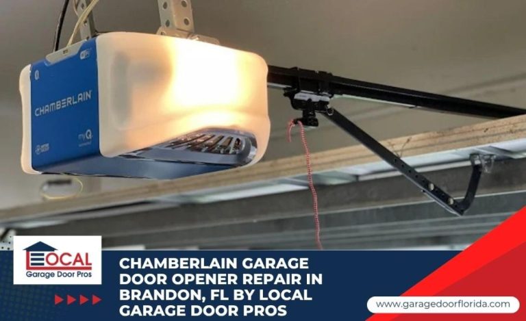 An illuminated Chamberlain myQ smart garage door opener unit mounted on a ceiling, glowing brightly with an app download tag hanging from it.