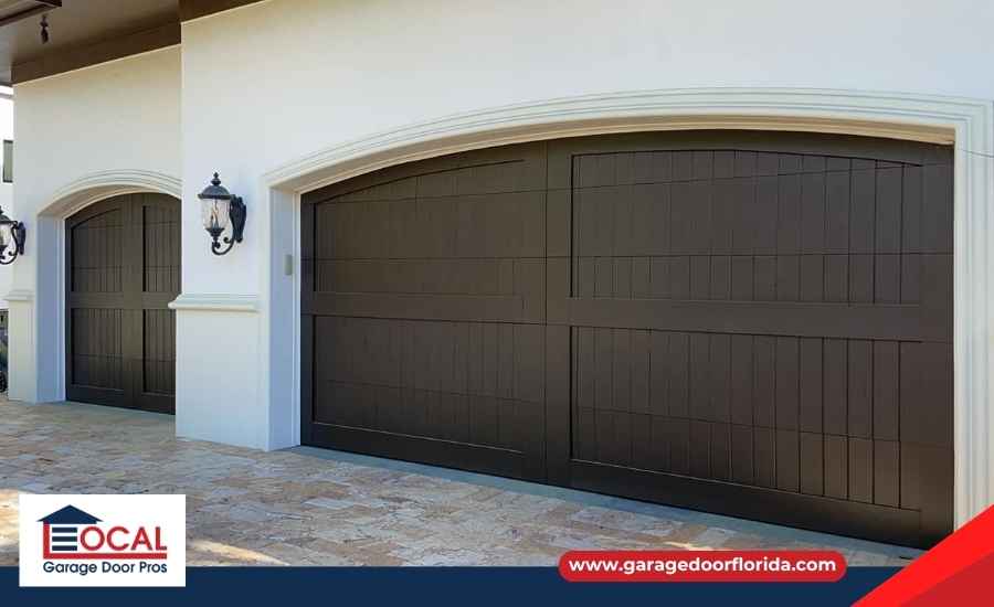 A newly installed custom garage door closed securely on a clean, modern residential property.
