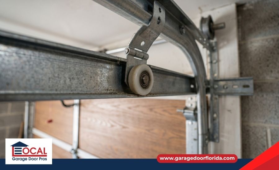 Close-up of a garage door track and roller system during a routine
