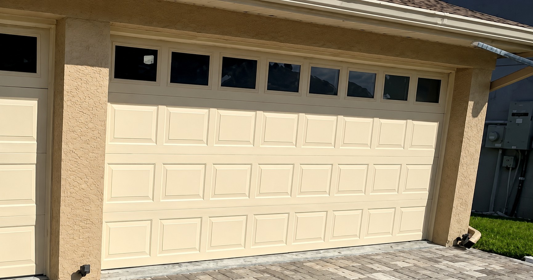 Before: existing cream-colored garage doors