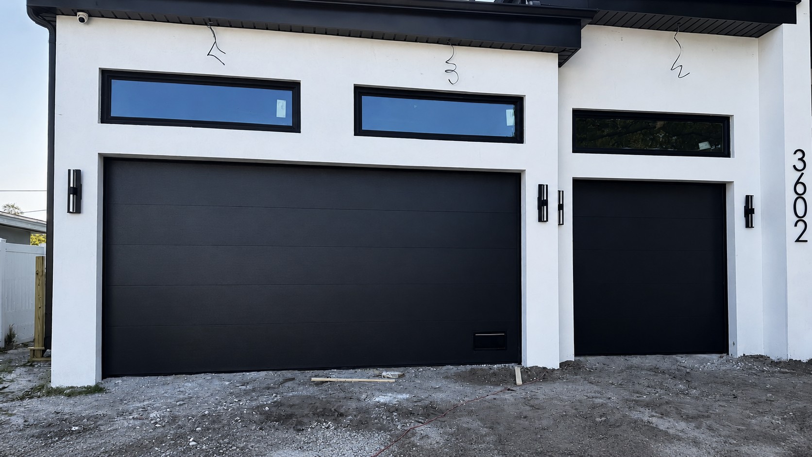After: modern home with sleek black garage doors installed