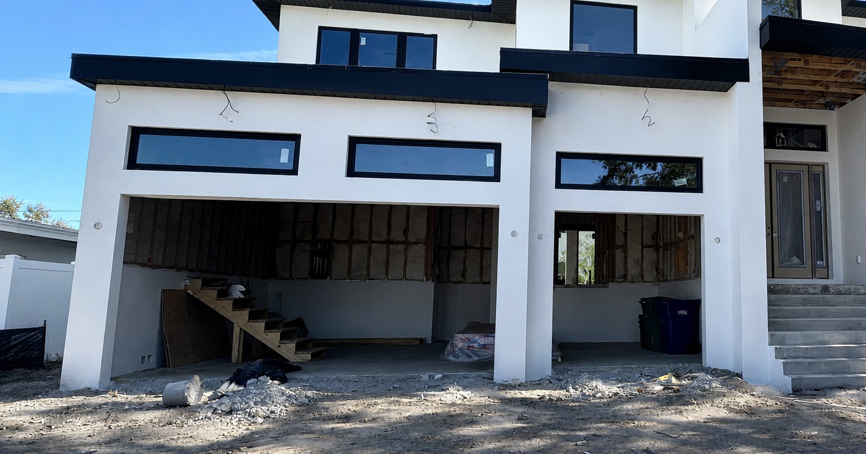 Before: modern new construction home before garage doors were installed