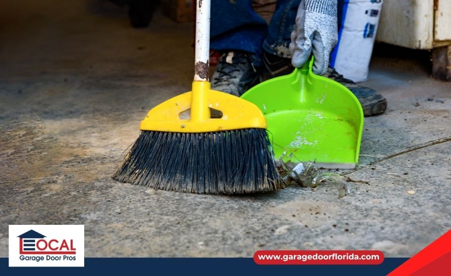 Sweeping leaves and dirt away from the garage door threshold
